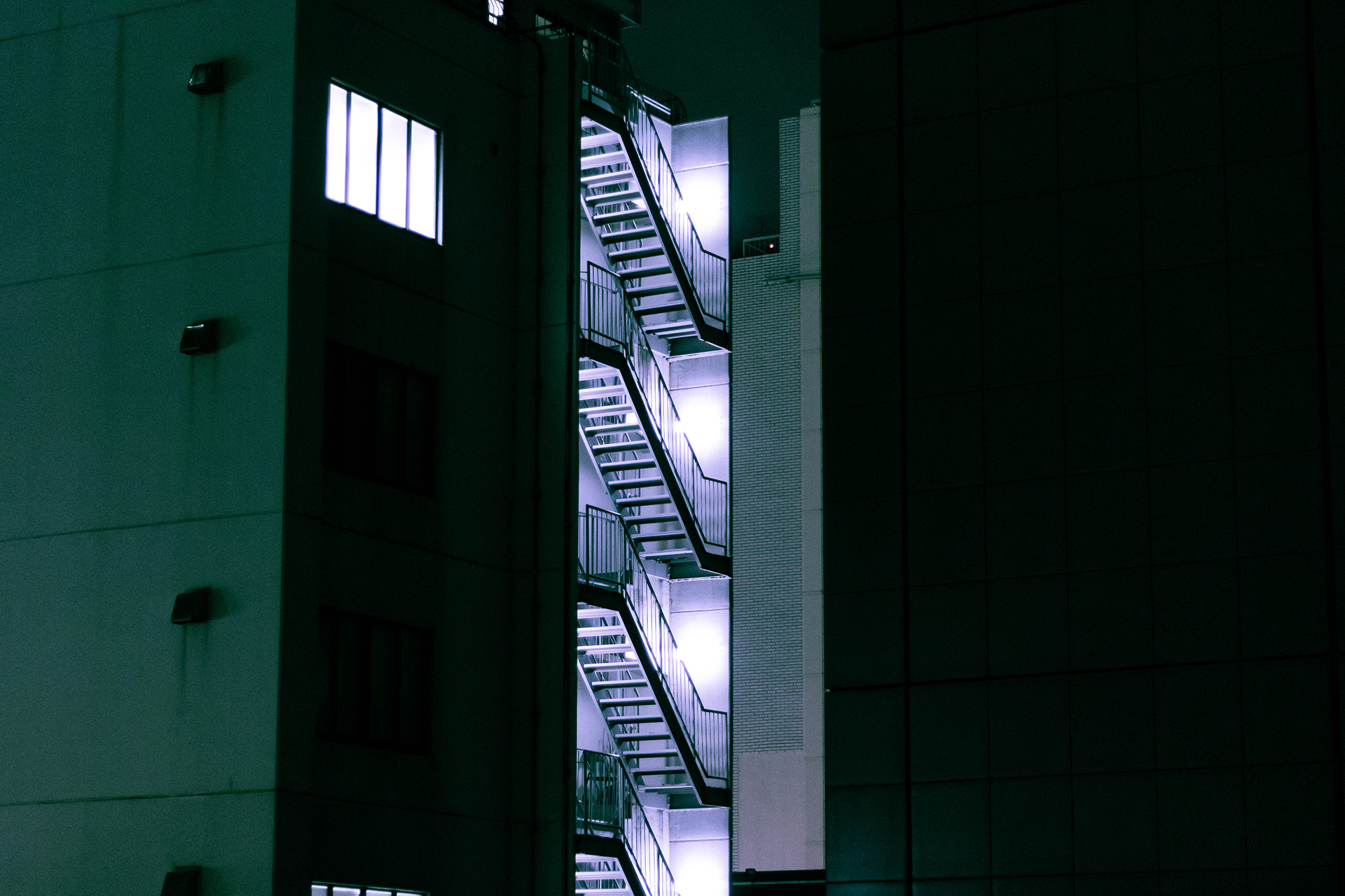 Zoom-in to a dimly lit stairway at night.